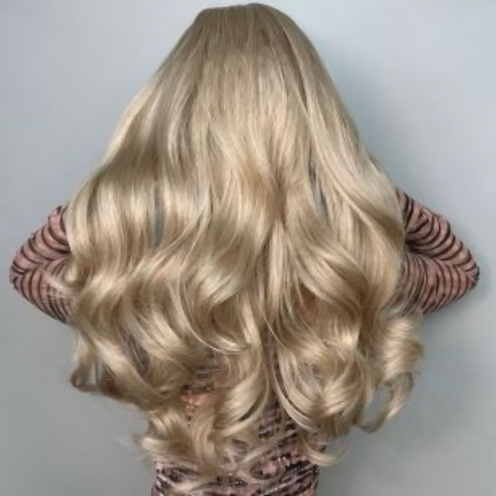Close-up of Champagne Blonde curly wig highlighting the natural bounce and texture of the curls.